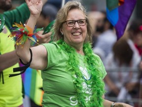 Green Party of Canada leader Elizabeth May waves during the 2018 Toronto Pride Parade on June 24, 2018.