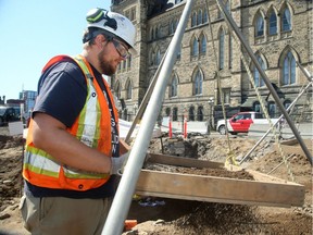 Archeology team member Calum Argent uses a sifter to sort through the discarded soil to check for historical items.  The foundations of Barrack Hill — that was built before Parliament in 1827 — is slowly being uncovered by a team of archeologists beside Centre Block.