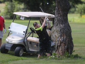 Donny Domenico watches his playing partner David Kealey shoot during the Ottawa Sun Scramble at Manderley on the Green on Monday.   Tony Caldwell/Ottawa Sun