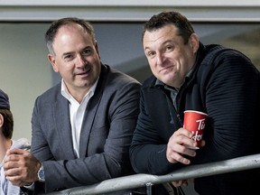 General manager Pierre Dorion (left) and head coach D.J. Smith watch their players at the Ottawa Senators development camp at the Bell Sensplex in June 2019.