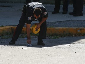 Toronto Police mark evidence at 7 Tree Sparroway, a quadrangle TCHC housing complex northwest of Finch Ave. E. and Leslie St., after a shooting on Sunday.