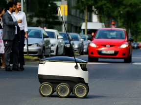 A Starship Technologies commercial delivery robot crosses a street during a live demonstration in front of the headquarters of Metro AG in Duesseldorf, Germany, June 7, 2016.