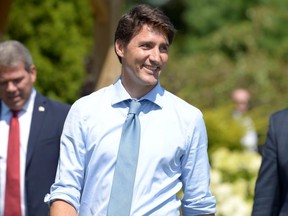 Prime Minister Justin Trudeau walks to the podium to speak with reporters about a watchdog's report that he breached ethics rules by trying to influence a corporate legal case regarding SNC-Lavalin, in Niagara-on-the-Lake, August 14, 2019. REUTERS/Andrej Ivanov