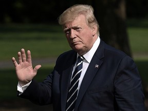 President Donald Trump waves as he returns to the White House in Washington on July 21, 2019. (OLIVIER DOULIERY/AFP/Getty Images)