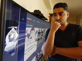 Walli Mohammad looks at a bullet hole in his TV after gunfire erupted at a striple mall at Glencairn and Marlee Aves. sending four people to hospital on Saturday.