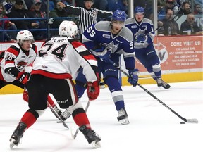 Lucas Peric of the Ottawa 67's — tries to block a shot by Quinton Byfield of the Sudbury Wolves during OHL playoff action at the Sudbury Community Arena in Sudbury, Ont. on April 11, 2019.