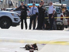 Police officers are seen at the scene of the stabbings in Kingston on Thursday, Sept. 12, 2019.