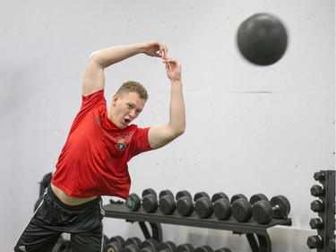 Brady Tkachuk throws a medicine ball as the Ottawa Senators begin training camp with medicals and fitness testing