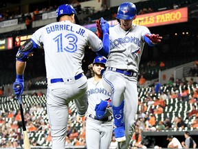 Cavan Biggio, right, of the Blue Jays celebrates with Lourdes Gurriel Jr. after hitting a two-run home run in the third inning of Tuesday's game against the Orioles.