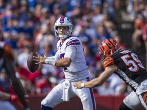 Josh Allen #17 of the Buffalo Bills pulls up to pass the ball just before a hit by Nick Vigil #59 of the Cincinnati Bengals during the fourth quarter at New Era Field on September 22, 2019 in Orchard Park, New York. Buffalo defeats Cincinnati 21-17. (Brett Carlsen/Getty Images)