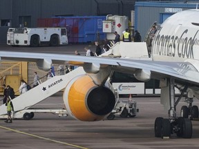 Passengers disembark a Thomas Cook aircraft at Manchester Airport on September 23, 2019 in Manchester, United Kingdom. The collapse of the 178-year-old travel firm triggered a massive repatriation effort, as the British Civil Aviation Authority chartered aircraft to bring around 150,000 travelers back to the UK. The firm's closure also jeopardized 22,000 jobs worldwide, including 9,000 in the UK.