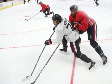 Nick Paul (R) battles against Jonathan Aspirot of the Ottawa Senators during training camp in Ottawa, September 13, 2019.