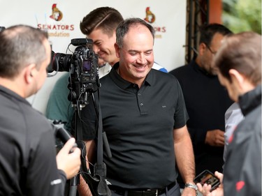 Sens GM Pierre Dorion (centre) shares a laugh with the media before the event. Ottawa Senators players and staff took to the Marshes Golf Club Tuesday for the Annual Bell Senators Charity Golf Classic, where foursomes are rounded out with players to raise money for the Sens Foundation.