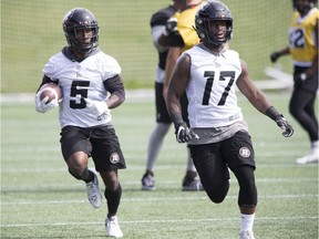 Stefan Logan, left, follows DeVonte Dedmon up the field during practice at TD Place stadium on Thursday.