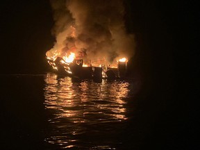 In this photo released by the Santa Barbara County Fire Department on September 2, 2019, A boat burns off the coast of Santa Cruz Island, California. - Rescuers were scrambling Monday to reach more than 30 people who were sleeping below deck when their scuba-diving boat caught fire off the California coast, with reports of "numerous fatalities." A major rescue operation was underway for the dozens of people trapped aboard the 75-foot (22-meter) boat, near Santa Cruz Island off the coast from Los Angeles, the Coast Guard tweeted. (Mike ELIASON / Santa Barbara County Fire Department / AFP)