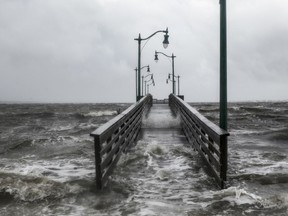 Strong gusts of wind and bands of heavy rain cover a walkway at the Jensen Beach Causeway Park in Jensen Beach, Florida on Tuesday.