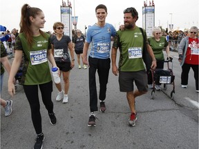Emilio Dutra-Lidington, who lost his right leg and part of his right hand in a boating accident just over a year ago, takes part in the Army Run 5K for ill and injured, supported by his dad Leo and sister Isabella on Sunday.