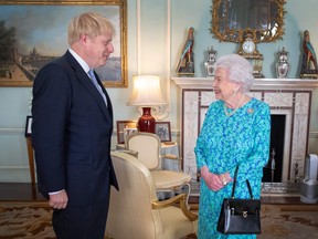 In this file photo taken on July 24, 2019, the Queen welcomes newly elected leader of the Conservative party, Boris Johnson during an audience in Buckingham Palace, London on July 24, 2019, where she invited him to become Prime Minister and form a new government. (VICTORIA JONES/AFP/Getty Images)
