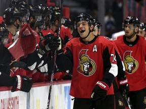Senators’ Mark Borowiecki high-fives teammates during their 4-3 victory over the Maple Leafs at the Canadian Tire Centre on Wednesday.  THE CANADIAN PRESS