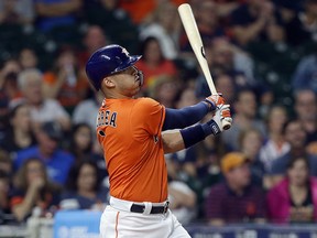 HOUSTON, TEXAS - SEPTEMBER 20: Carlos Correa #1 of the Houston Astros hits a home run in the third inning against the Los Angeles Angels at Minute Maid Park on September 20, 2019 in Houston, Texas.