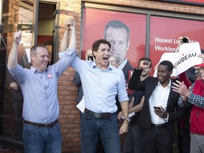 Prime Minister Justin Trudeau raises the arm of Carleton Liberal candidate Chris Rogers (left) attends as he attends and election campaign event in Manotick, Ontario, Monday September 9,2019.
