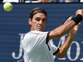 Roger Federer of Switzerland hits the ball against David Goffin of Belguim during their Round Four Men's Singles match at the U.S. Open at the USTA Billie Jean King National Tennis Center in New York on Sunday.