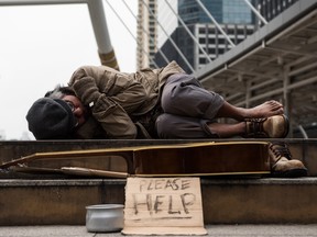 beggar or Homeless man sleep in city at winter