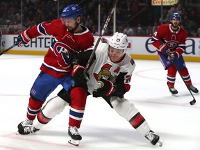 The Montreal Canadiens' Tomas Tatar and the Ottawa Senators' Mark Borowiecki battle for the puck during the first period at the Bell Centre.