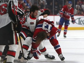 Ottawa Senators winger Scott Sabourin and Montreal Canadiens centre Max Domi fight during the first period, Sept. 28, 2019.