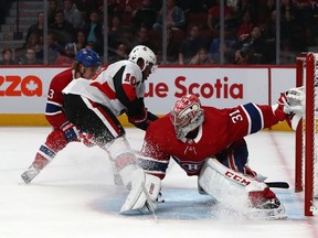 Senators' Anthony Duclair (10) scores against Canadiens goaltender Carey Price as Max Domi (13) defends at the Bell Centre in Montreal on Saturday, Sept. 28, 2019.