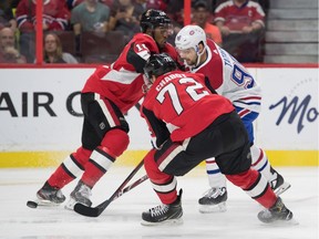 Montreal Canadiens left wing Tomas Tatar (right) is checked by Ottawa Senators left wing Anthony Duclair (left) and defenseman Thomas Chabot (middle) in the first period at the Canadian Tire Centre on Saturday.