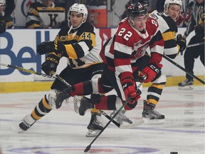 The Ottawa 67's Jack Quinn, the eventual overtime hero, is tripped up by the Kingston Frontenacs' Lucas Peric at the Leon's Centre in Kingston on Friday, Sept. 27, 2019.