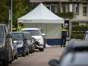 Policemen work on September 18, 2019, on the site of a shooting in the Amsterdam district of Buitenveldert, where Dutch lawyer Derk Wiersum was shot dead. (MICHEL VAN BERGEN/AFP/Getty Images)