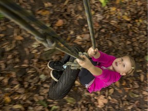 Jasmine MacDonald, 7, plays on the tire swing at the pop-up adventure playground on Friday.