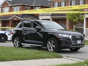 A black Audi behind police tape on Checkerberry Crescent in Brampton on Monday September 16, 2019. Veronica Henri/Toronto Sun