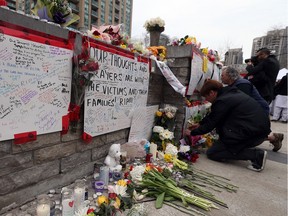 Residents pay tribute at a memorial near the scene on Yonge Street in Toronto a day after a van struck and killed 10 and injured 16 others in April 2018.