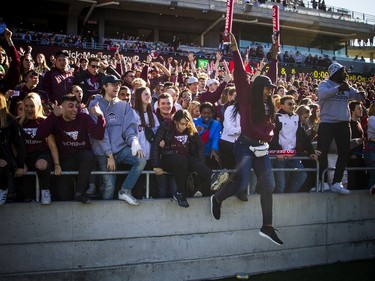 uOttawa fans storm onto the field at the end of Saturday's Panda Game.