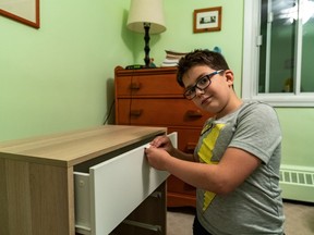 Nine-year-old Jonathan Goldstein, who assembles IKEA furniture as a weekend and after-school gig, places the first drawer into an Askvoll dresser he assembled in Côte-St-Luc on Oct. 10, 2019.