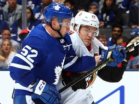 'We need to set that standard at home so that when teams come into this rink it's not going to be an easy night,' said the Senators' Mark Borowiecki, seen battling Martin Marincin of the Toronto Maple Leafs in the season opener on Wednesday.