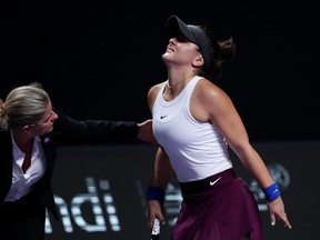 Bianca Andreescu of Canada is attended to after sustaining an injury to her left leg during her Women's Singles match against Karolina Pliskova of the Czech Republic on Day Four of the 2019 Shiseido WTA Finals at Shenzhen Bay Sports Center on October 30, 2019 in Shenzhen, China. (Photo by Lintao Zhang/Getty Images)