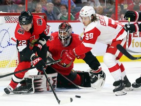 Anders Nilsson of the Ottawa Senators makes the save as Nikita Zaitsev (left) battles  Tyler Bertuzzi of the Detroit Red Wings during second period of NHL action at Canadian Tire Centre in Ottawa, October 23, 2019.   Photo by Jean Levac/Postmedia
