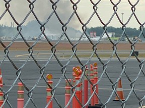 Smoke is seen from Windsor Locks at the site of an airplane crash in Bradley International Airport, Connecticut, Oct. 2, 2019, in this picture obtained from social media. (Bryan St. Amand via REUTERS)