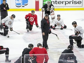Head coach D.J. Smith talks to Senators players at the end of practice at Canadian Tire Centre on Tuesday.