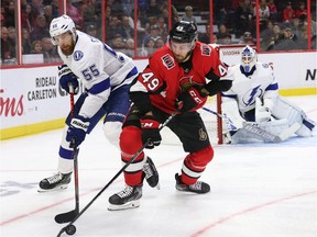 Senators winger Scott Sabourin battles for puck possession with the Lightning's Braydon Coburn during an early-season game at Canadian Tire Centre.