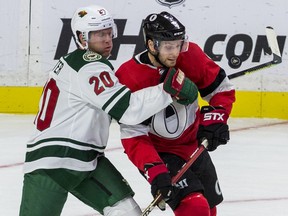 Ottawa Senators Bobby Ryan battles for a loose puck with Minnesota Wild Gary Suter during NHL action at the Canadian Tire Centre on Monday.
