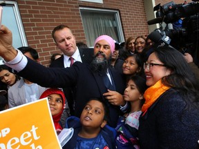 Canada's New Democratic Party (NDP) leader Jagmeet Singh, accompanied by Beaches-East York candidate Mae J. Nam, takes a selfie with kids during an election campaign visit stop at Crescent Town Elementary School in Toronto, Ontario, Canada October 17, 2019.