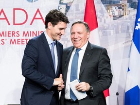 Prime minister of Canada Justin Trudeau (L) with premier of Quebec François Legault (R) shake hands during a meeting with Canadian prime ministers in Montreal, on December 7, 2018 at the Marriott Chateau Champlain.