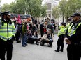 Police monitor as climate activists protest in London on Thursday.