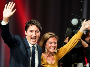 Canadian Prime Minister Justin Trudeau and his wife, Sophie Gregoire Trudeau, wave on stage after the federal election.