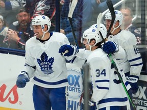 Maple Leafs defenceman Cody Ceci (left) celebrates with teammates after scoring a goal against the Blue Jackets in the second period at Nationwide Arena in Columbus, Ohio, on Friday, Oct. 4, 2019.